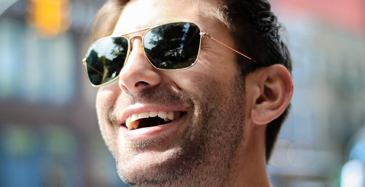 Man wearing PROGEAR Urban U-1512 gold prescription sunglasses, showcasing stylish fit and glare-free polarized lenses for outdoor use.