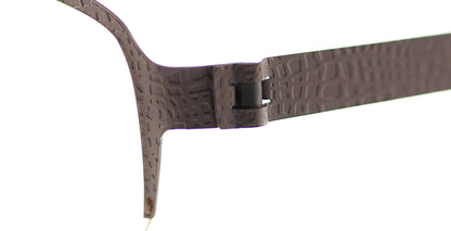 Close-up of Free Form Eyewear™ Titanium 14g feather-light eyeglasses, model FFA938, showing textured green half-frame with screwless hinge design.