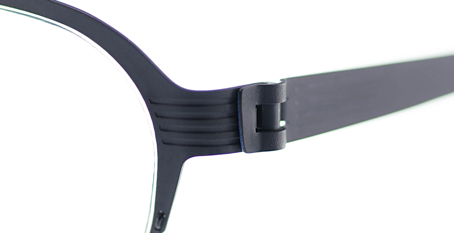 Close-up of Free Form Eyewear™ Model FFA931 titanium glasses in green, showcasing screwless hinge and half frame design. Luxury German lightweight frame.