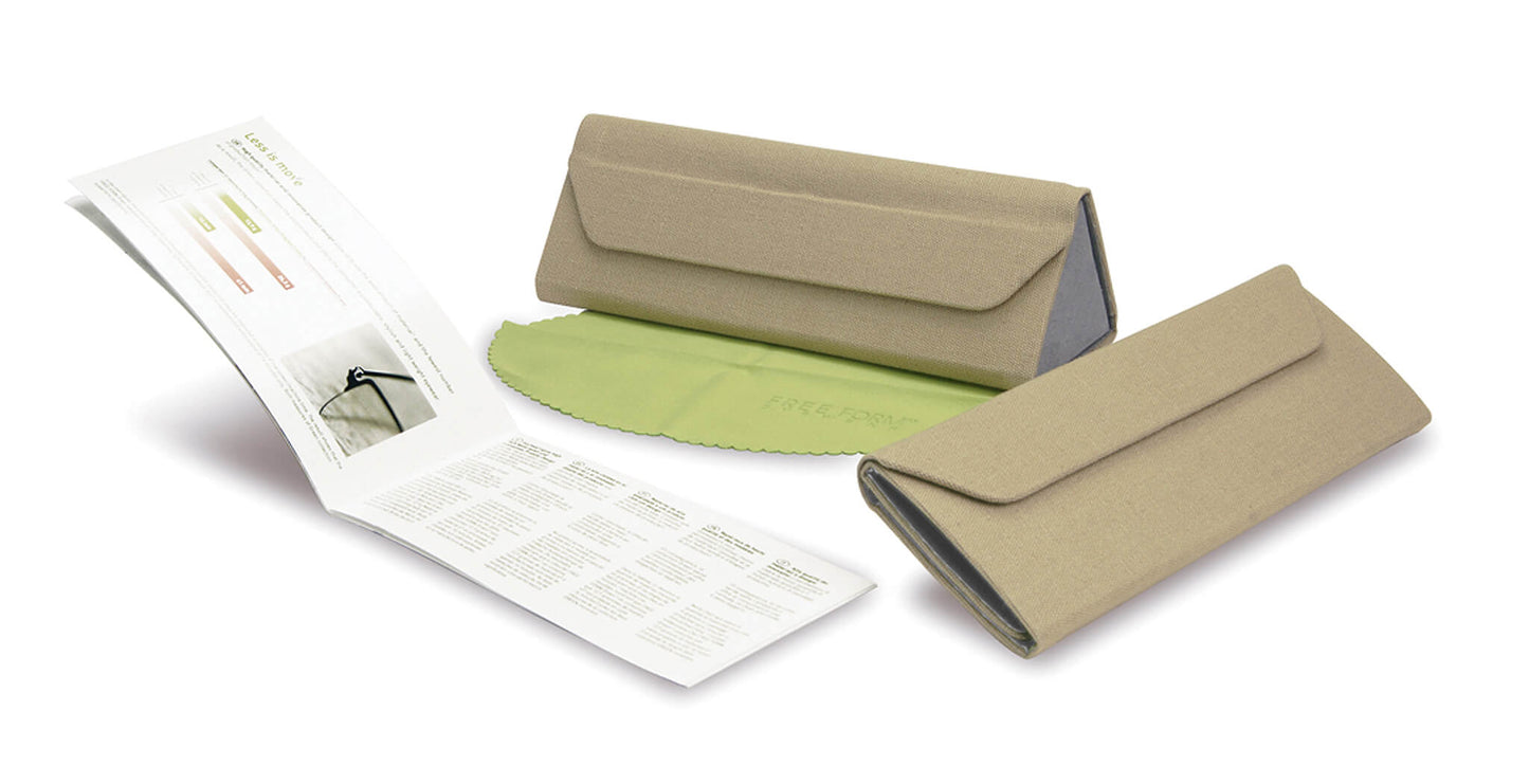 Free Form Eyewear™ titanium glasses case in beige with green microfiber cloth and instruction manual, showcasing eco-friendly luxury packaging.