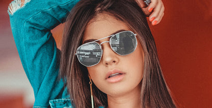 Woman wearing silver PROGEAR Urban U-1512 sunglasses with mirrored lenses, combining fashion and prescription sun protection.