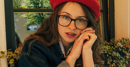 Woman wearing Free Form Eyewear™ Titanium 14g feather-light eyeglasses in green full frame, luxury German design for men and women. Stylish and lightweight titanium glasses ideal for blue light protection and strong prescriptions.