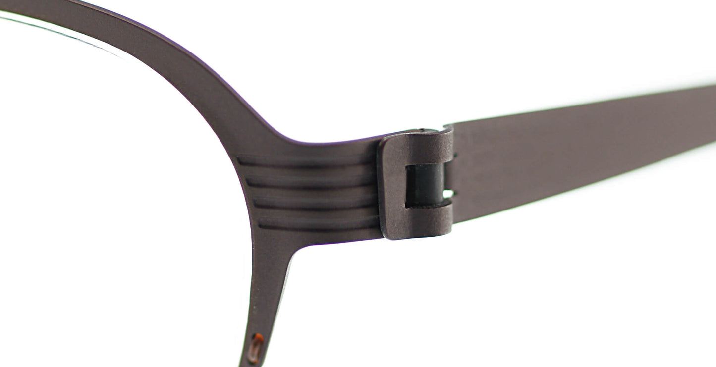 Close-up of Free Form Eyewear™ Titanium 14g feather-light eyeglasses in green, showing screwless hinge and half-frame German design. Ideal for men and women seeking luxury lightweight vision care.