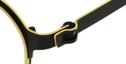 Close-up of Free Form Eyewear™ Titanium 14g luxury eyeglasses hinge in green and gold, showcasing screwless German design for lightweight comfort.