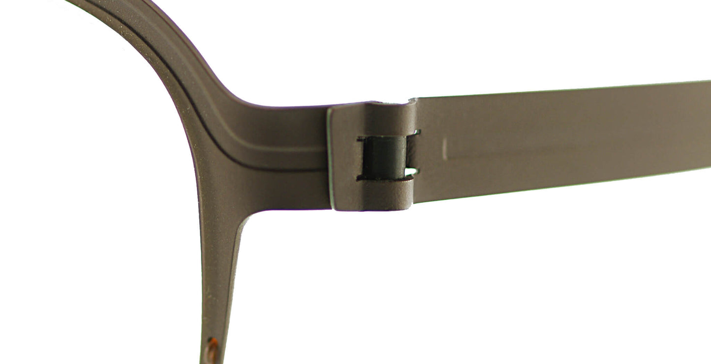 Close-up of Free Form Eyewear™ Model FFA934 titanium eyeglasses hinge in brown. Features screwless German-engineered design for durability and comfort.