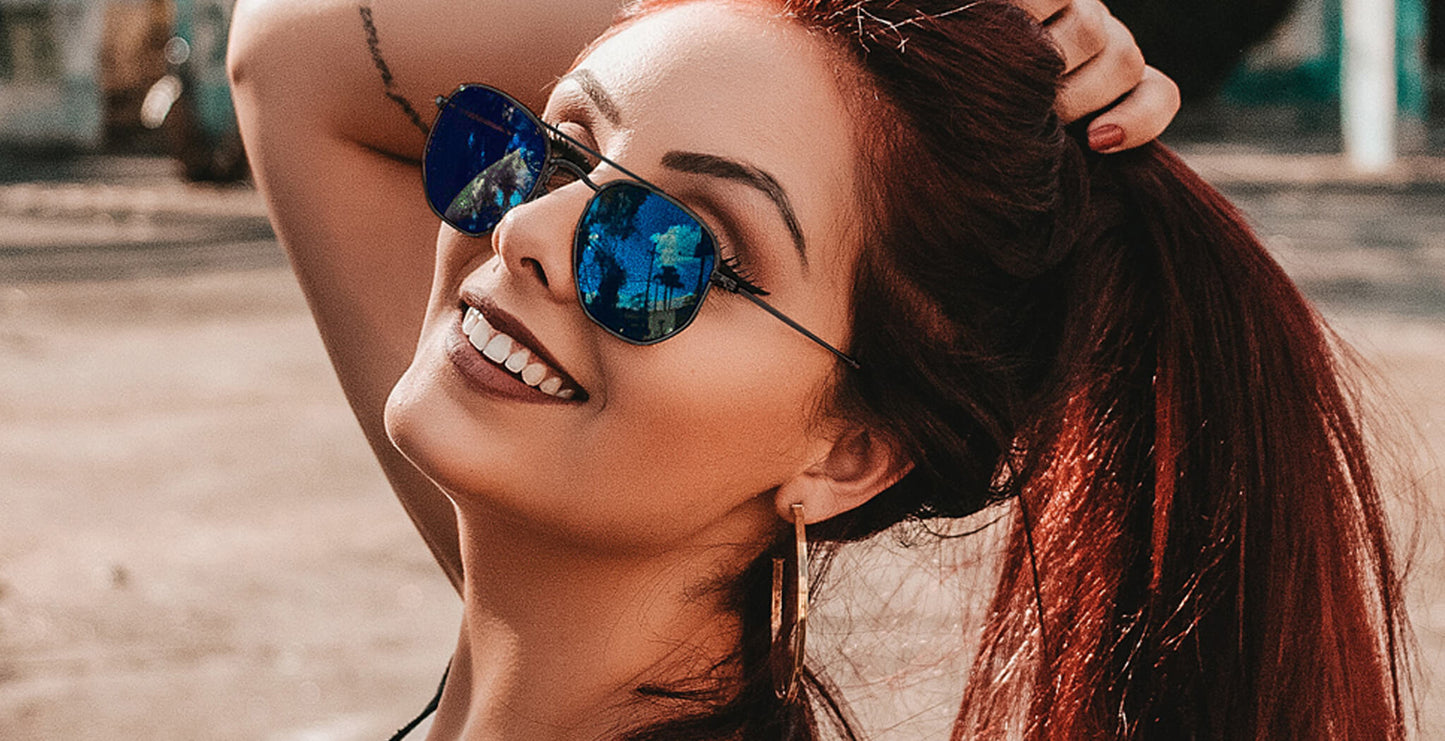 Woman wearing black PROGEAR Urban U-1512 sunglasses with blue mirrored lenses, combining fashion and prescription functionality.