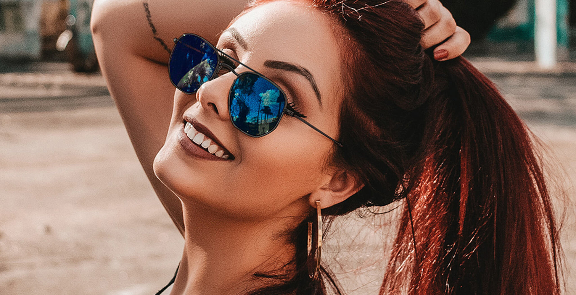Woman wearing black PROGEAR Urban U-1512 sunglasses with blue mirrored lenses, combining fashion and prescription functionality.