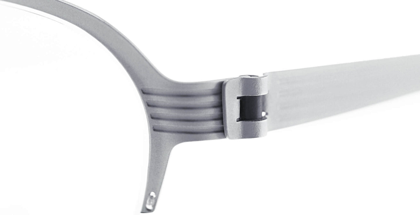 Close-up of Free Form Eyewear™ Titanium 14g luxury eyeglasses hinge, showcasing screwless German-engineered design in lightweight silver half frame.