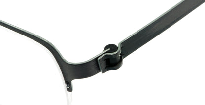 Close-up of Free Form Eyewear™ FFA904 green titanium half-frame glasses showcasing screwless hinge design. Lightweight 14g luxury German engineering.