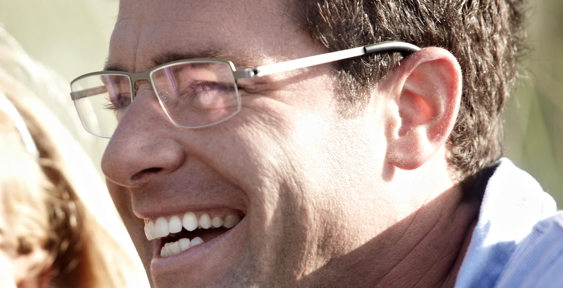 Man wearing Free Form Eyewear™ Titanium 14g feather-light half frame glasses in green. Luxury German design ideal for men seeking lightweight comfort.