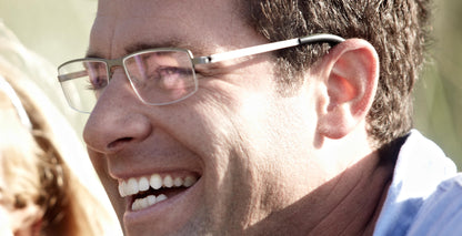 Man wearing Free Form Eyewear™ Titanium 14g feather-light half frame glasses in green. Luxury German design ideal for men seeking lightweight comfort.