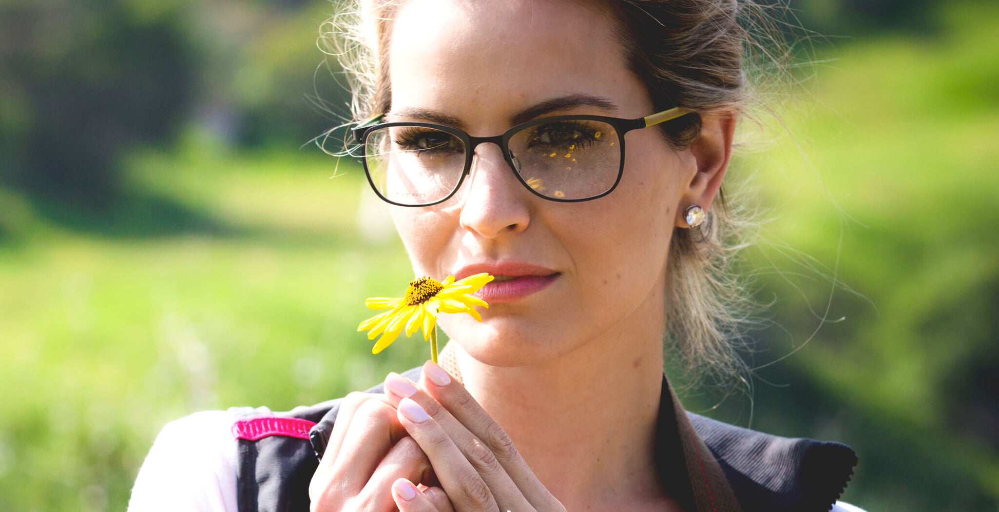 Free Form Eyewear™ Titanium 14g feather-light eyeglasses in green full frame worn by woman outdoors. Luxury German design for men and women.